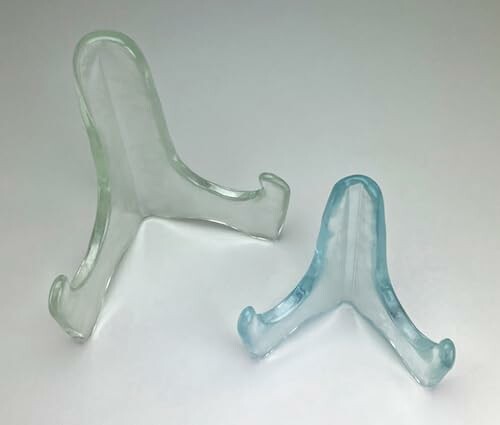Two clear plastic display stands on a white background
