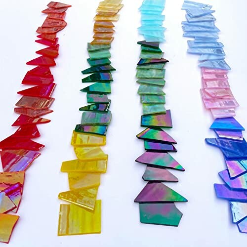 Colorful glass pieces arranged in rows on a white background.