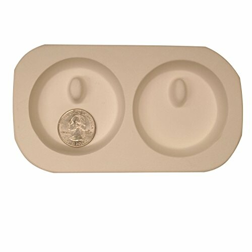 Microwave egg cooker tray with a coin for scale.