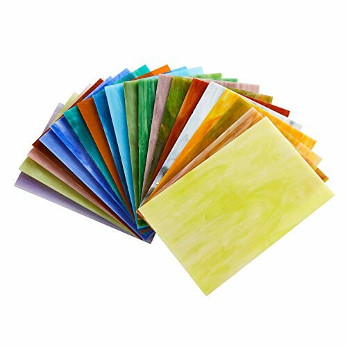 Assorted multicolor stained glass sheets fanned out.