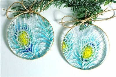 Glass ornaments with peacock feather design and gold bows.