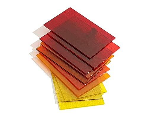 Stack of transparent colored glass sheets in red, orange, and yellow hues.